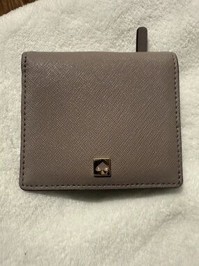 kate spade mauve taupe saffiano bifold wallet with gold spade emblem